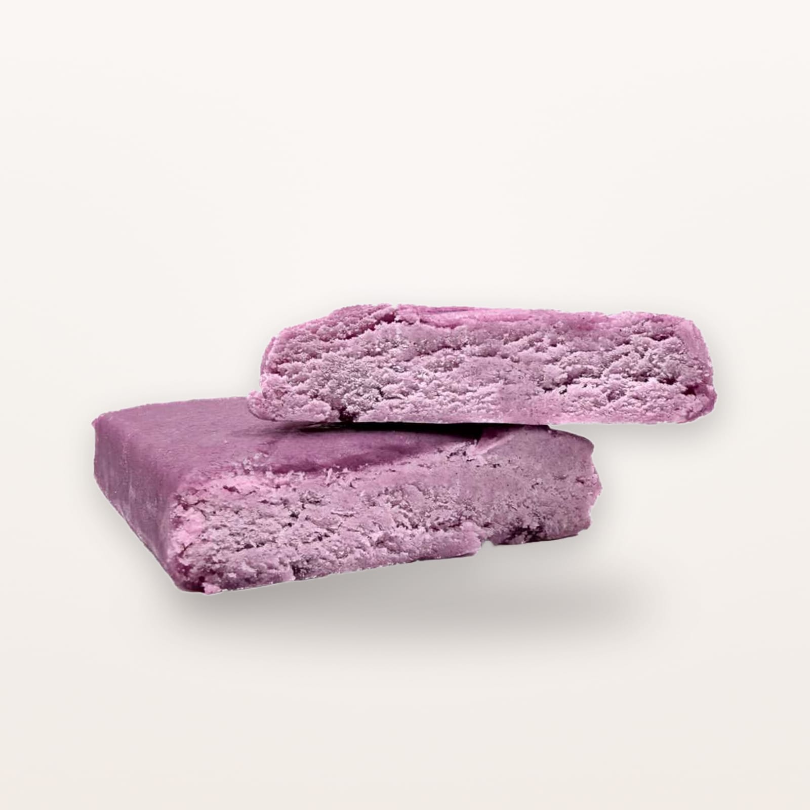 Two pieces of purple shatter stacked on a pale background